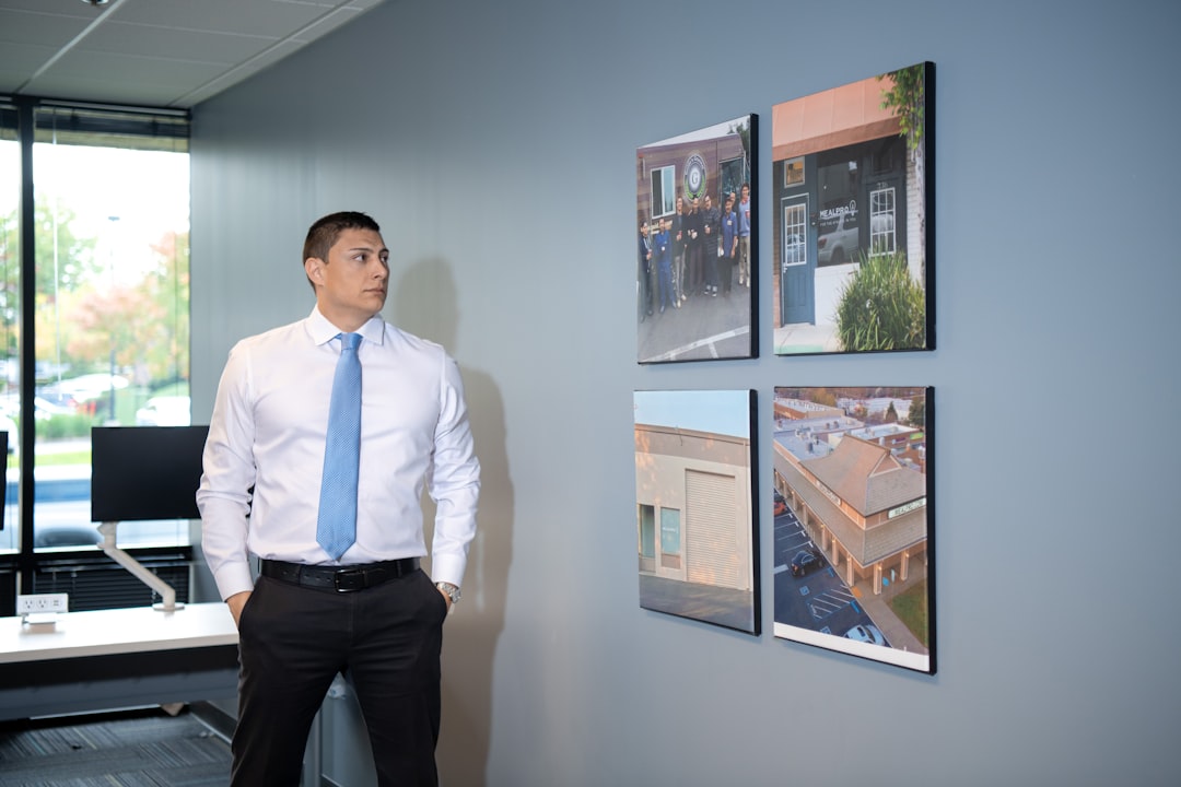 A man in a suit and tie standing in an office