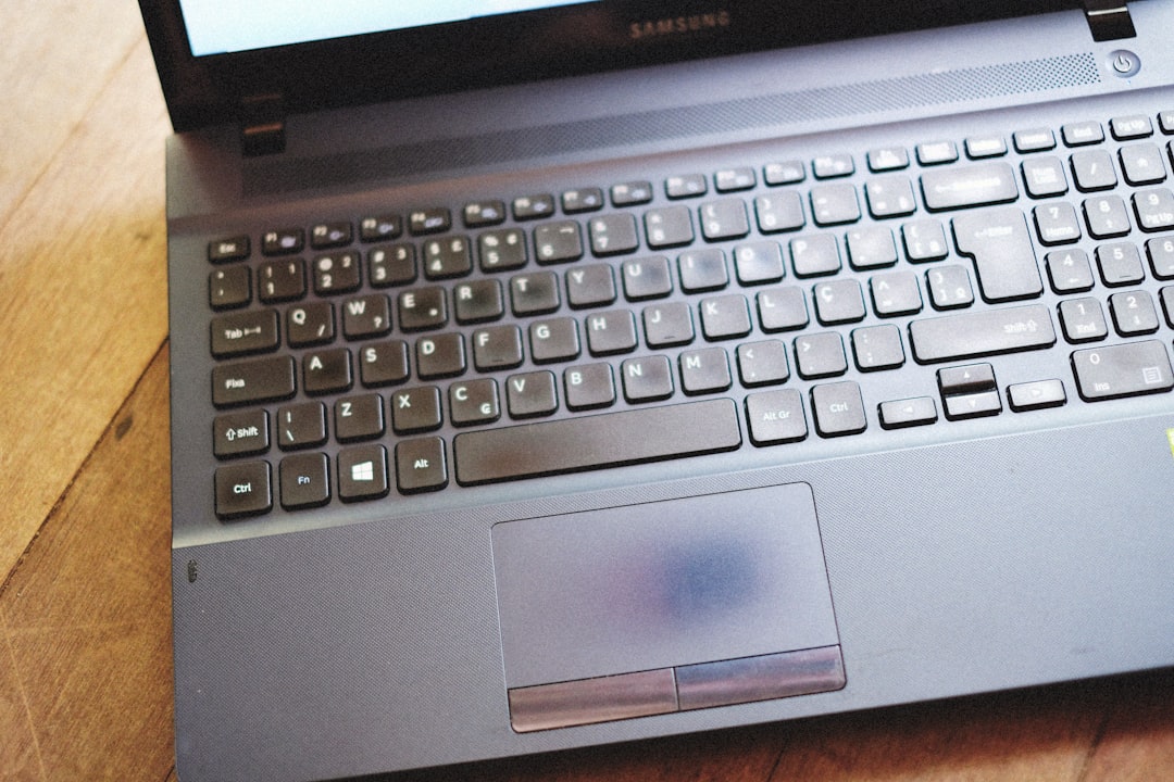 a laptop computer sitting on top of a wooden table