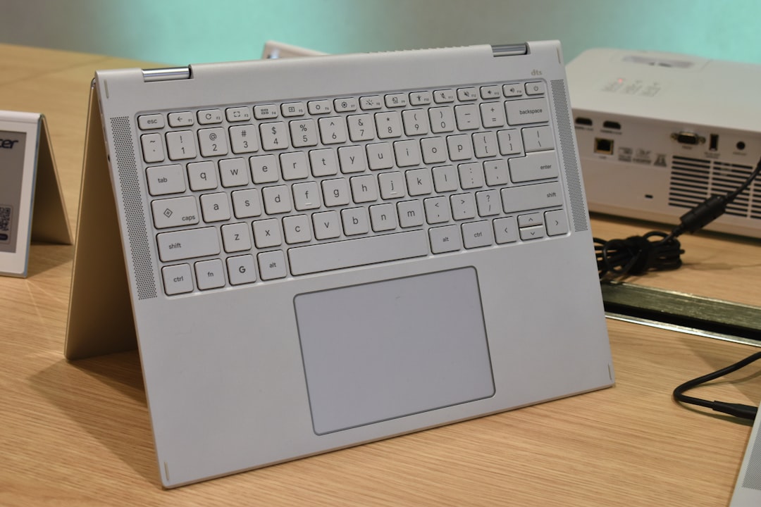 A white laptop with a full keyboard and trackpad.