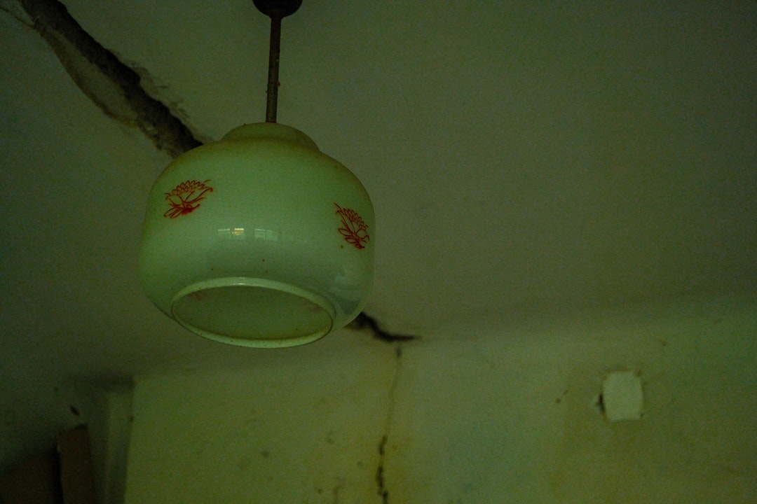 Old ceiling light fixture with cracked walls
