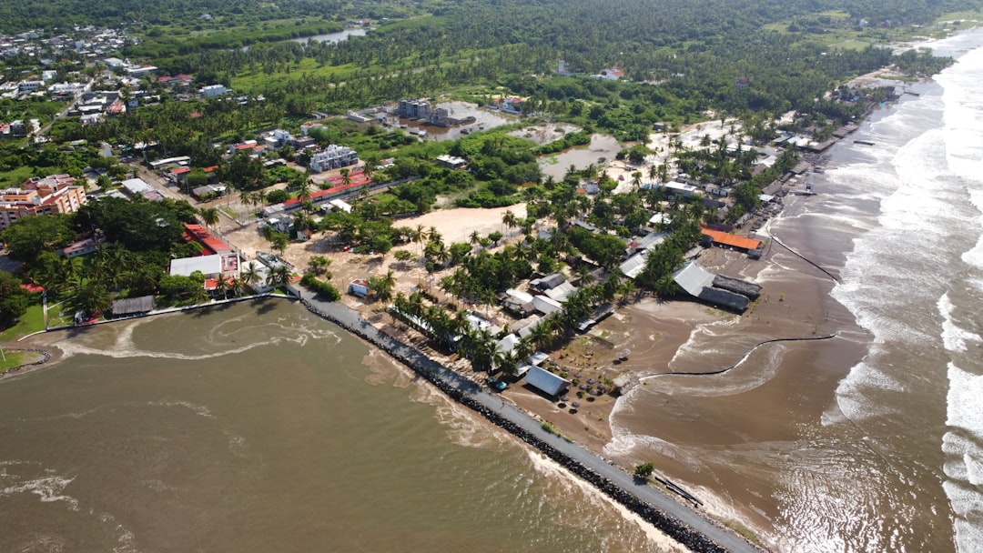 Flooded coastal town with debris and high waves