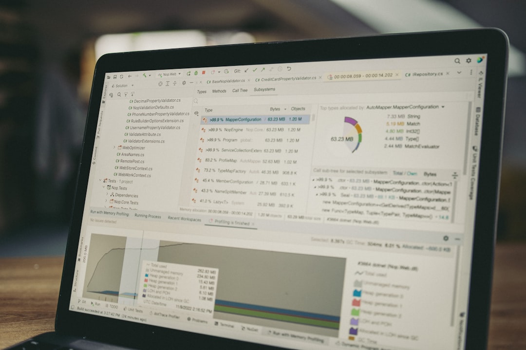 Laptop screen displaying code and data charts.
