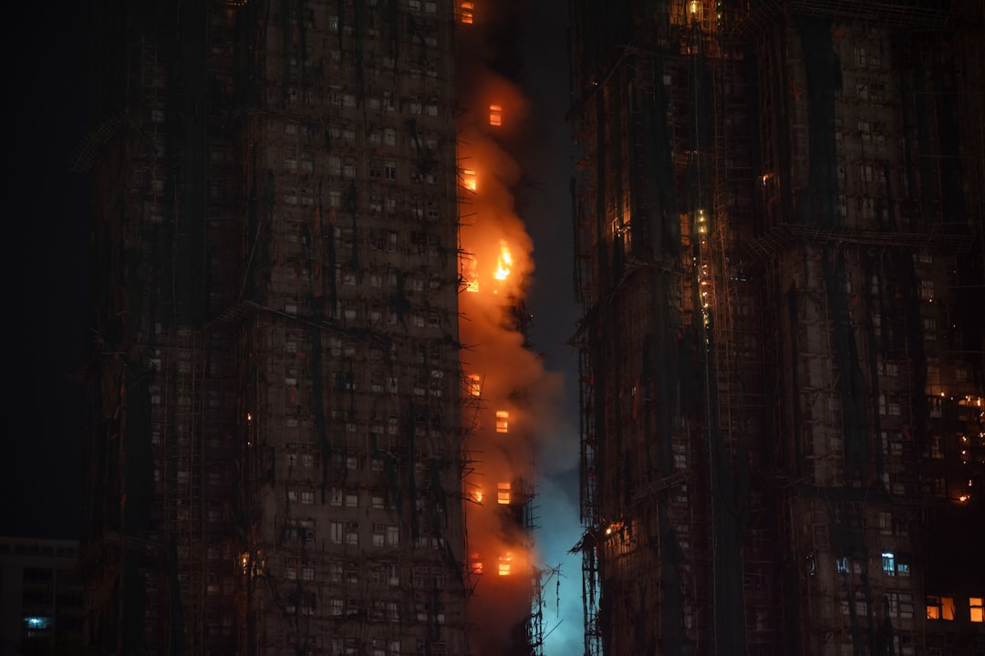 High-rise building engulfed in flames at night