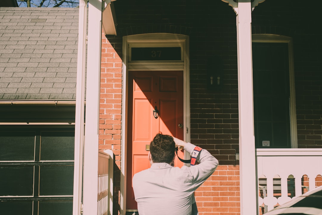 a person standing in front of a red door
