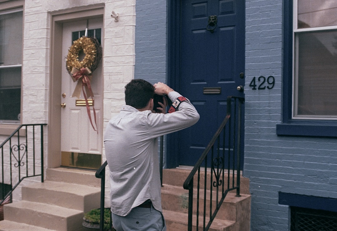 a man standing in front of a blue door