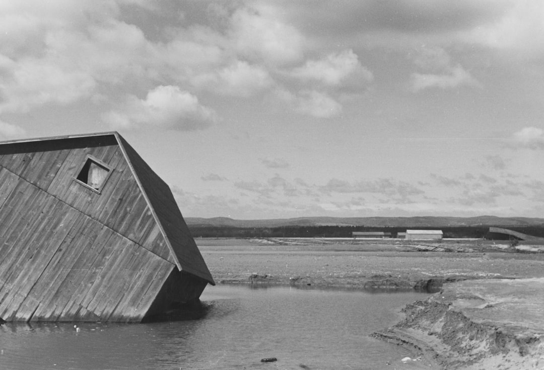 A tilted wooden structure partially submerged in water.